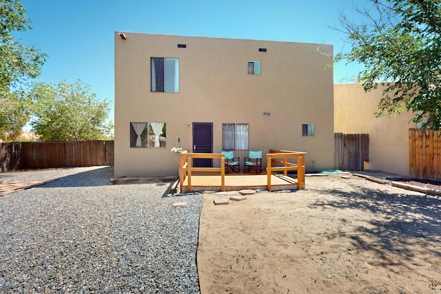 3039 Prenda De Oro Dr NW, Albuquerque, NM 87120 - rear view of property featuring stucco siding, a fenced backyard, and a deck