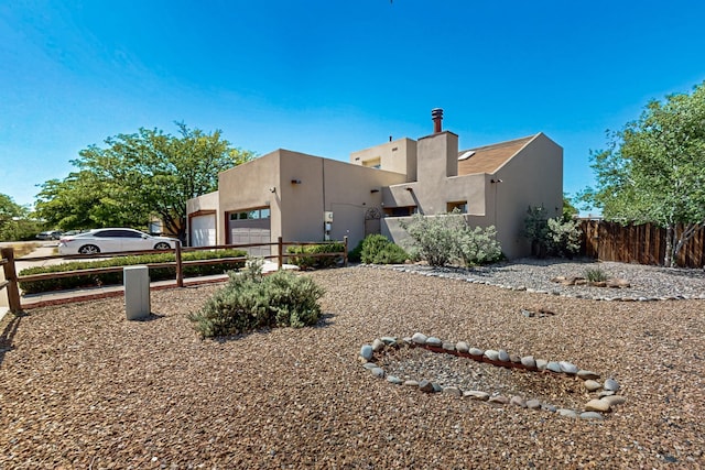 3039 Prenda De Oro Dr NW, Albuquerque, NM 87120 - rear view of property featuring stucco siding and a garage