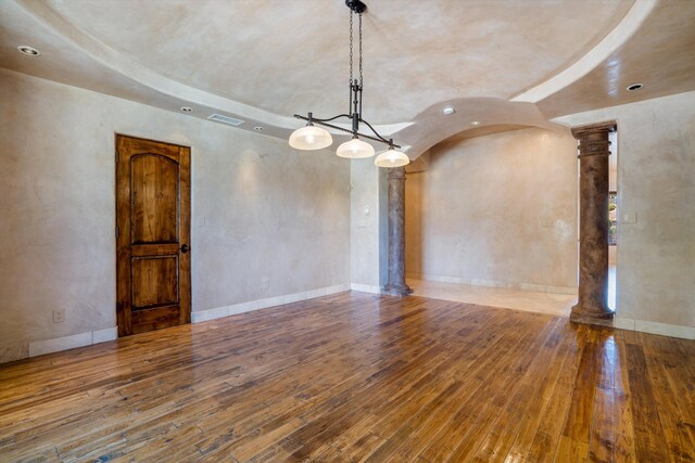 9301 Black Farm Ln NW, Albuquerque, NM 87114 - spare room featuring ornate columns, hardwood / wood-style floors, and arched walkways