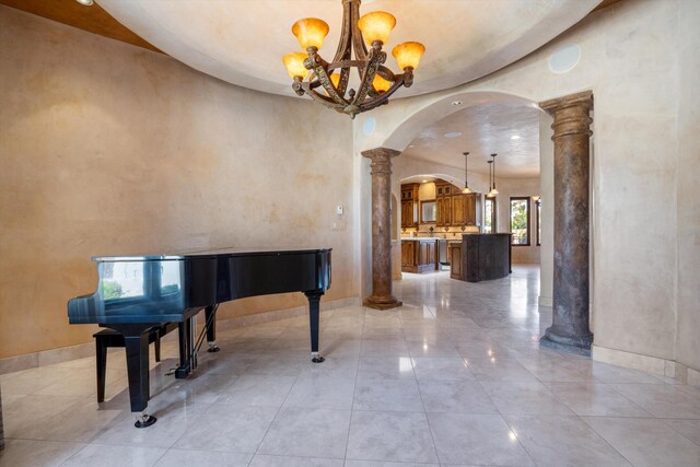 9301 Black Farm Ln NW, Albuquerque, NM 87114 - unfurnished room featuring arched walkways, decorative columns, and a chandelier