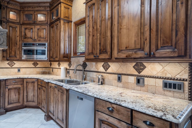 9301 Black Farm Ln NW, Albuquerque, NM 87114 - kitchen featuring stainless steel appliances, backsplash, light stone countertops, and glass insert cabinets