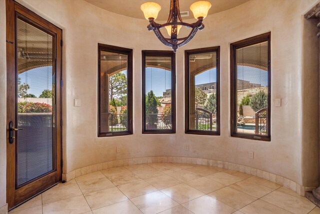 9301 Black Farm Ln NW, Albuquerque, NM 87114 - tiled empty room with a chandelier and baseboards