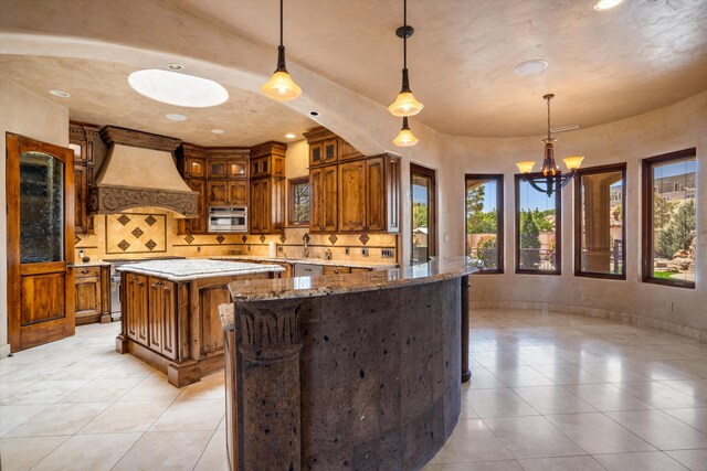 9301 Black Farm Ln NW, Albuquerque, NM 87114 - kitchen with stainless steel range with electric stovetop, custom exhaust hood, tasteful backsplash, brown cabinetry, and recessed lighting
