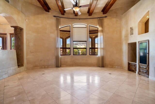9301 Black Farm Ln NW, Albuquerque, NM 87114 - empty room with beam ceiling, ceiling fan, a towering ceiling, ornate columns, and arched walkways