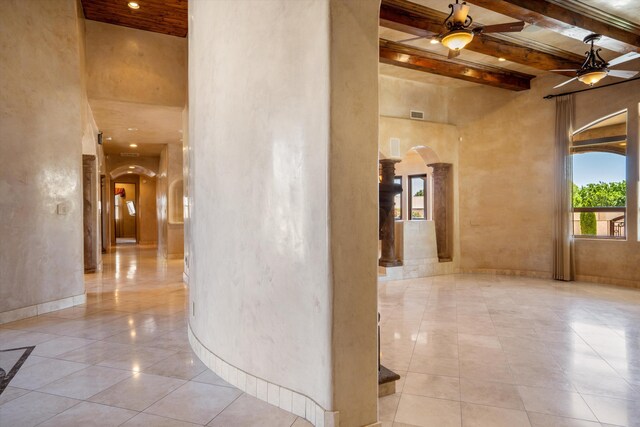 9301 Black Farm Ln NW, Albuquerque, NM 87114 - corridor featuring arched walkways, a high ceiling, beamed ceiling, tile patterned flooring, and ornate columns