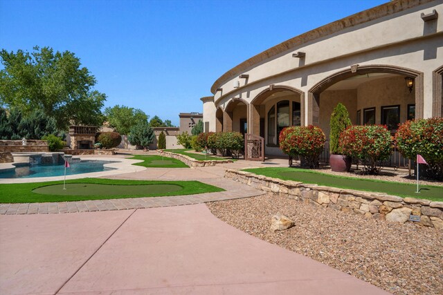 9301 Black Farm Ln NW, Albuquerque, NM 87114 - view of yard featuring a putting green, a patio, and an outdoor pool