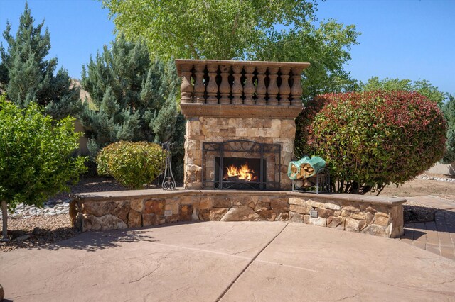 9301 Black Farm Ln NW, Albuquerque, NM 87114 - view of patio / terrace featuring an outdoor stone fireplace