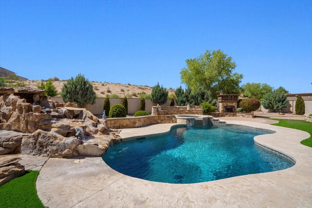 9301 Black Farm Ln NW, Albuquerque, NM 87114 - view of pool featuring an outdoor stone fireplace, a patio area, and a pool with connected hot tub