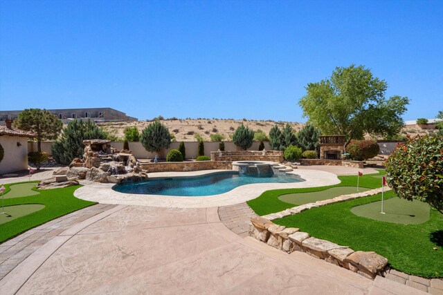 9301 Black Farm Ln NW, Albuquerque, NM 87114 - view of swimming pool with an area to practice putting, an outdoor stone fireplace, a patio, and a fenced backyard