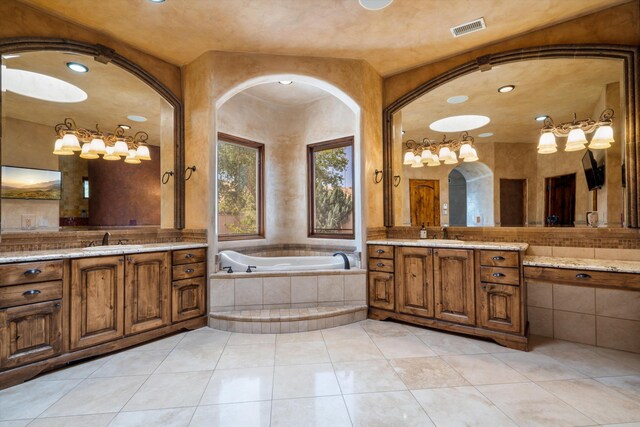 9301 Black Farm Ln NW, Albuquerque, NM 87114 - full bathroom featuring a garden tub, two vanities, tile patterned floors, and recessed lighting