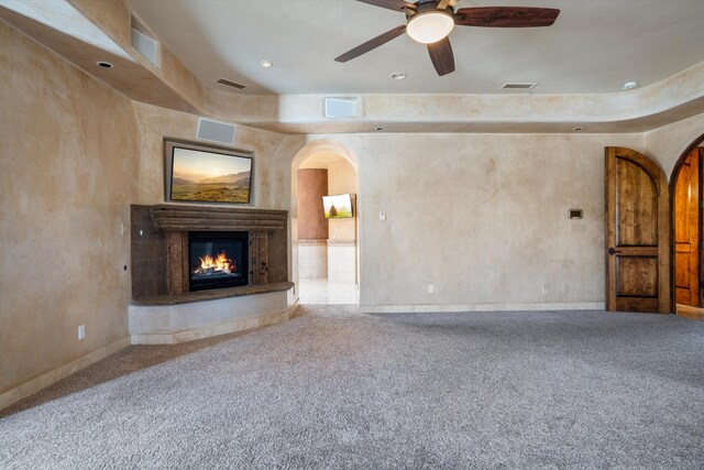 9301 Black Farm Ln NW, Albuquerque, NM 87114 - unfurnished living room with arched walkways, carpet, a glass covered fireplace, and recessed lighting