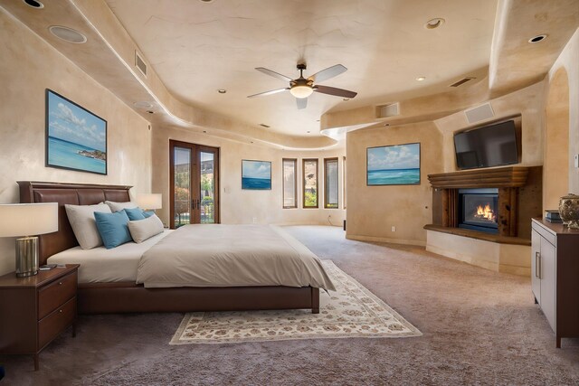 9301 Black Farm Ln NW, Albuquerque, NM 87114 - carpeted bedroom featuring a glass covered fireplace, access to exterior, a raised ceiling, french doors, and recessed lighting