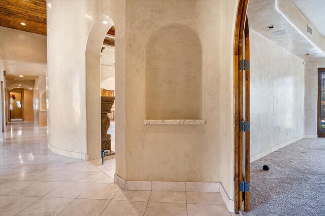 9301 Black Farm Ln NW, Albuquerque, NM 87114 - hallway with arched walkways, carpet floors, tile patterned flooring, and recessed lighting