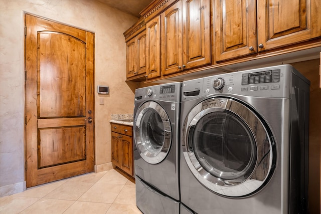 9301 Black Farm Ln NW, Albuquerque, NM 87114 - washroom with independent washer and dryer, cabinet space, and light tile patterned floors