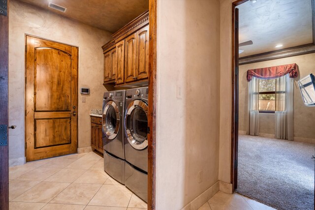 9301 Black Farm Ln NW, Albuquerque, NM 87114 - laundry room with cabinet space, independent washer and dryer, light tile patterned floors, and light colored carpet