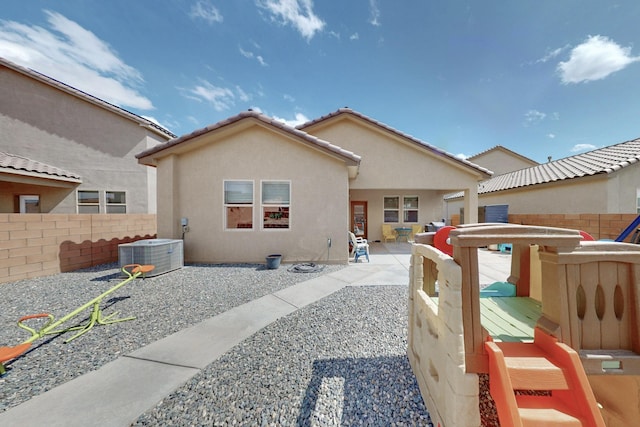 1854 Valle Vista Rd NW, Los Lunas, NM 87031 - back of property with central AC unit, stucco siding, and a patio area