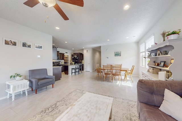 1854 Valle Vista Rd NW, Los Lunas, NM 87031 - living area featuring a ceiling fan, recessed lighting, light tile patterned flooring, and baseboards