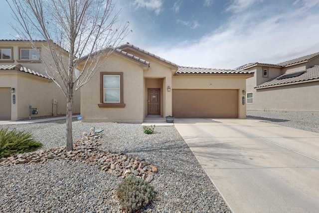 1854 Valle Vista Rd NW, Los Lunas, NM 87031 - view of front of house with a garage, stucco siding, a tile roof, and concrete driveway
