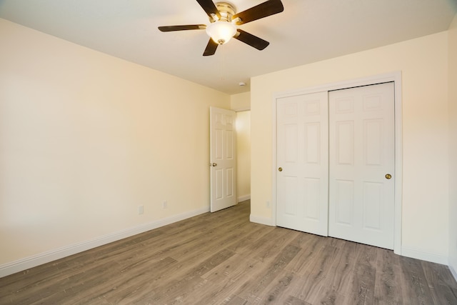 7113 Avignon Ct NW, Albuquerque, NM 87114 - unfurnished bedroom featuring wood finished floors, a closet, baseboards, and a ceiling fan