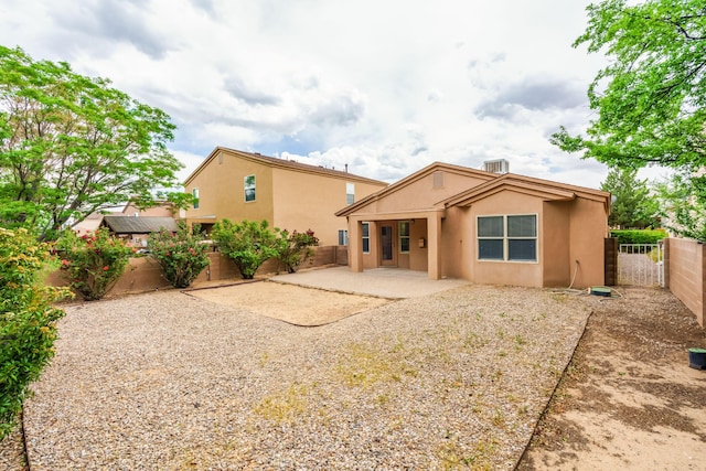 7113 Avignon Ct NW, Albuquerque, NM 87114 - back of house featuring stucco siding, a patio area, and a fenced backyard