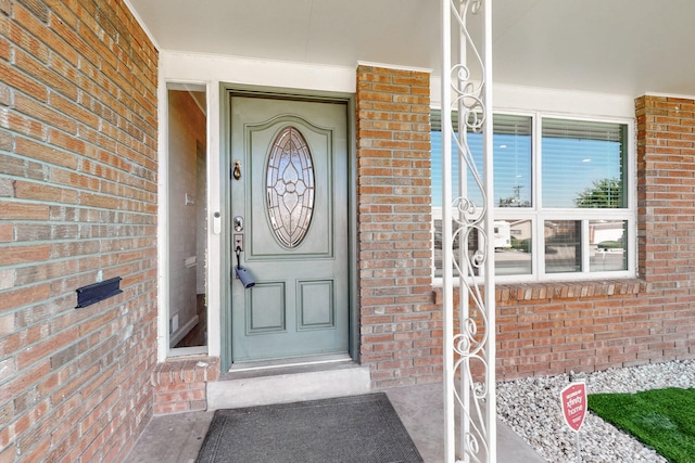 2912 Alcazar St NE, Albuquerque, NM 87110 - doorway to property with brick siding and covered porch