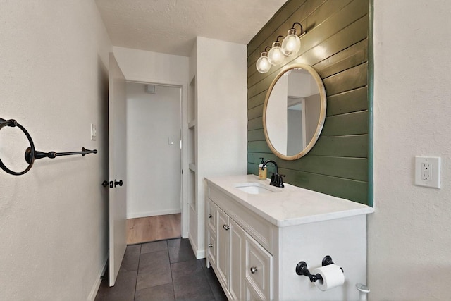 2912 Alcazar St NE, Albuquerque, NM 87110 - bathroom featuring vanity, tile patterned flooring, baseboards, and a textured ceiling
