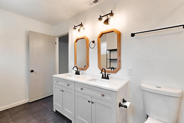 2912 Alcazar St NE, Albuquerque, NM 87110 - bathroom featuring double vanity, toilet, tile patterned floors, and baseboards
