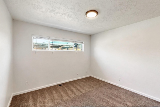 2912 Alcazar St NE, Albuquerque, NM 87110 - carpeted spare room featuring baseboards and a textured ceiling
