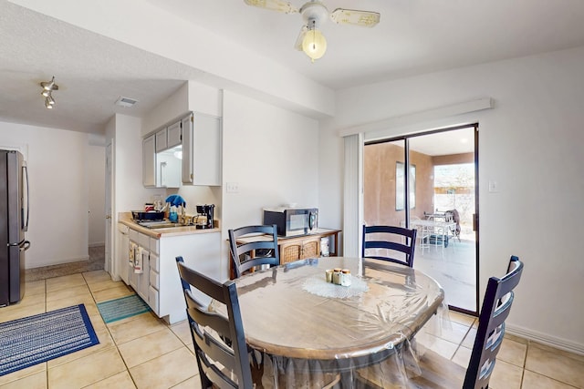 402 Calle Don Santiago NE, Los Lunas, NM 87031 - dining space with light tile patterned floors, baseboards, and a ceiling fan