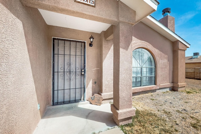 402 Calle Don Santiago NE, Los Lunas, NM 87031 - entrance to property featuring stucco siding and a chimney