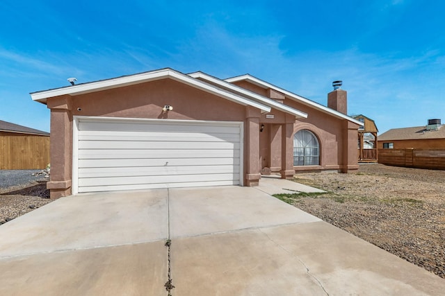 402 Calle Don Santiago NE, Los Lunas, NM 87031 - ranch-style home featuring stucco siding, an attached garage, and concrete driveway