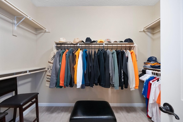 6413 Kings Cyn NE, Rio Rancho, NM 87144 - walk in closet featuring wood finished floors
