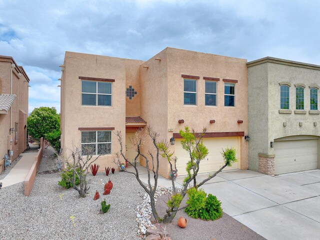 1921 Cortina Loop SE, Rio Rancho, NM 87124 - pueblo revival-style home featuring stucco siding, driveway, and an attached garage