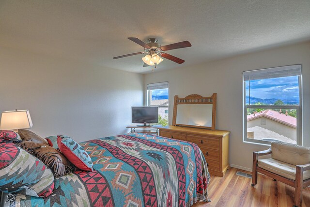 1921 Cortina Loop SE, Rio Rancho, NM 87124 - bedroom with light wood-style flooring, baseboards, and a ceiling fan