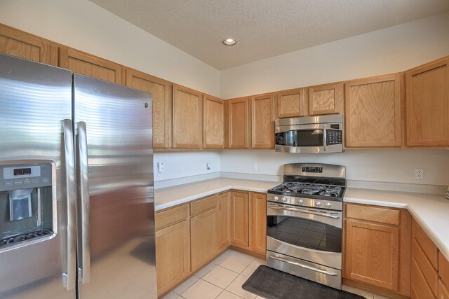 1921 Cortina Loop SE, Rio Rancho, NM 87124 - kitchen with stainless steel appliances, light countertops, light tile patterned floors, recessed lighting, and a textured ceiling