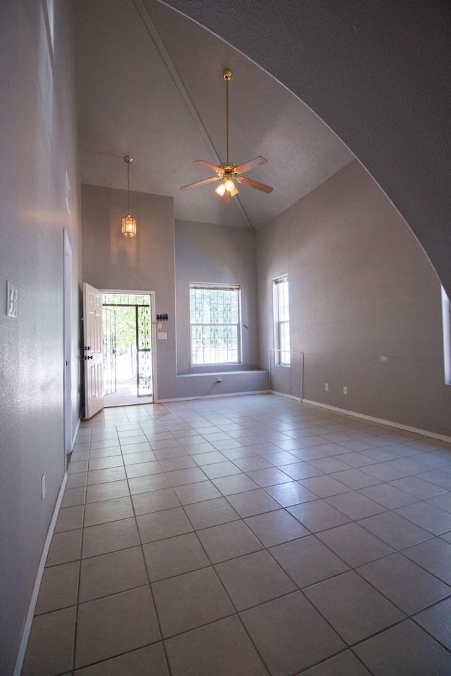 5112 W Lea Dr SW, Albuquerque, NM 87105 - empty room featuring high vaulted ceiling, tile patterned floors, ceiling fan, baseboards, and arched walkways