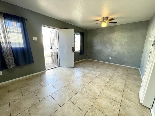 820 Apache Ave NW, Albuquerque, NM 87102 - unfurnished room featuring ceiling fan, a textured ceiling, light tile patterned floors, and baseboards