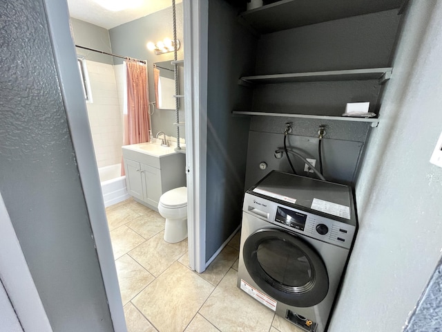 820 Apache Ave NW, Albuquerque, NM 87102 - laundry room with washer / clothes dryer and light tile patterned flooring