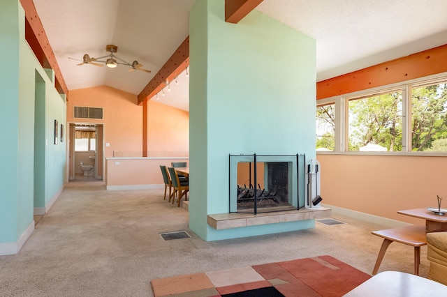 4818 Royene Ave NE, Albuquerque, NM 87110 - living area with carpet flooring, baseboards, a ceiling fan, and a tiled fireplace