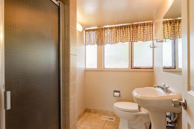 4818 Royene Ave NE, Albuquerque, NM 87110 - bathroom with tile patterned floors, a shower stall, and toilet