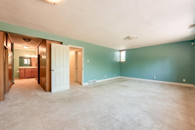 4818 Royene Ave NE, Albuquerque, NM 87110 - empty room with a textured ceiling, light colored carpet, and baseboards