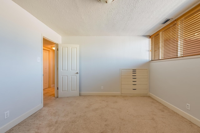 4818 Royene Ave NE, Albuquerque, NM 87110 - unfurnished bedroom with carpet flooring, a textured ceiling, and baseboards