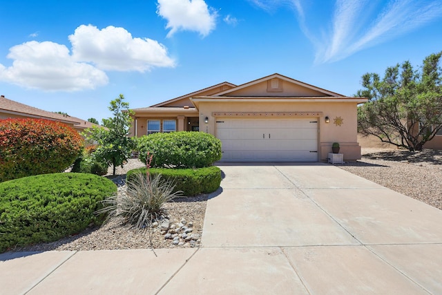 3401 Sun Mesa St SW, Los Lunas, NM 87031 - ranch-style house with stucco siding, driveway, and a garage