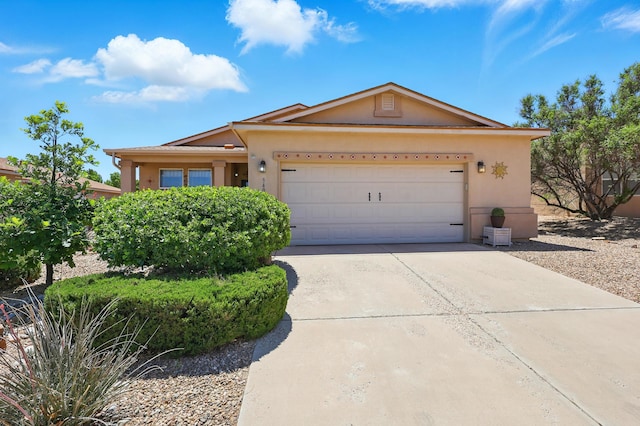 3401 Sun Mesa St SW, Los Lunas, NM 87031 - ranch-style house with stucco siding, concrete driveway, and a garage
