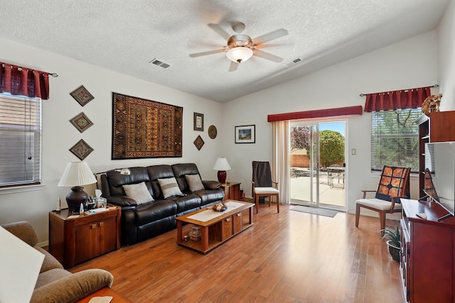 3401 Sun Mesa St SW, Los Lunas, NM 87031 - living area featuring ceiling fan, vaulted ceiling, a textured ceiling, and wood finished floors