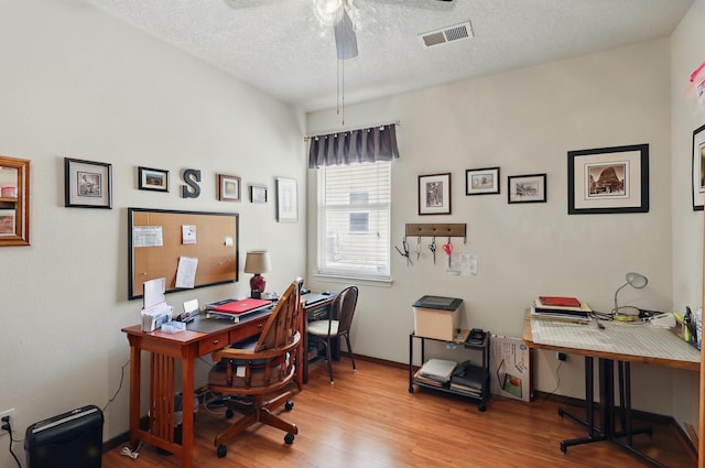 3401 Sun Mesa St SW, Los Lunas, NM 87031 - office featuring wood finished floors, a ceiling fan, a textured ceiling, and baseboards