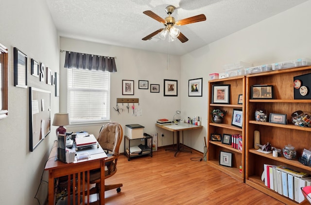 3401 Sun Mesa St SW, Los Lunas, NM 87031 - home office featuring ceiling fan, light wood finished floors, a textured ceiling, and baseboards