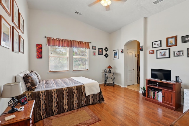 3401 Sun Mesa St SW, Los Lunas, NM 87031 - bedroom with vaulted ceiling, arched walkways, light wood-style flooring, a ceiling fan, and baseboards