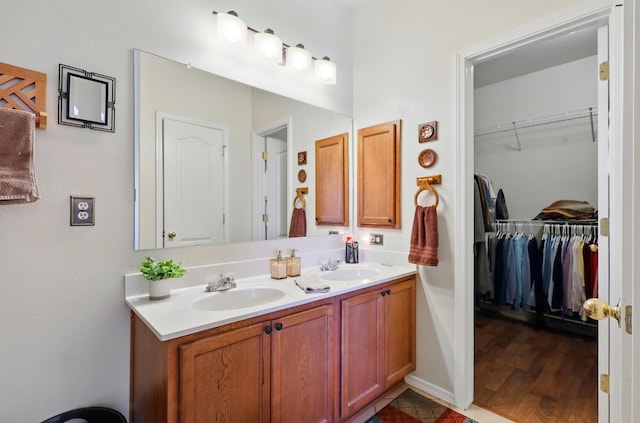3401 Sun Mesa St SW, Los Lunas, NM 87031 - full bath with double vanity, wood finished floors, and a walk in closet