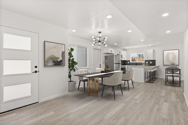 7525 Gill St NE, Albuquerque, NM 87109 - dining room with recessed lighting, light wood-type flooring, a chandelier, and baseboards